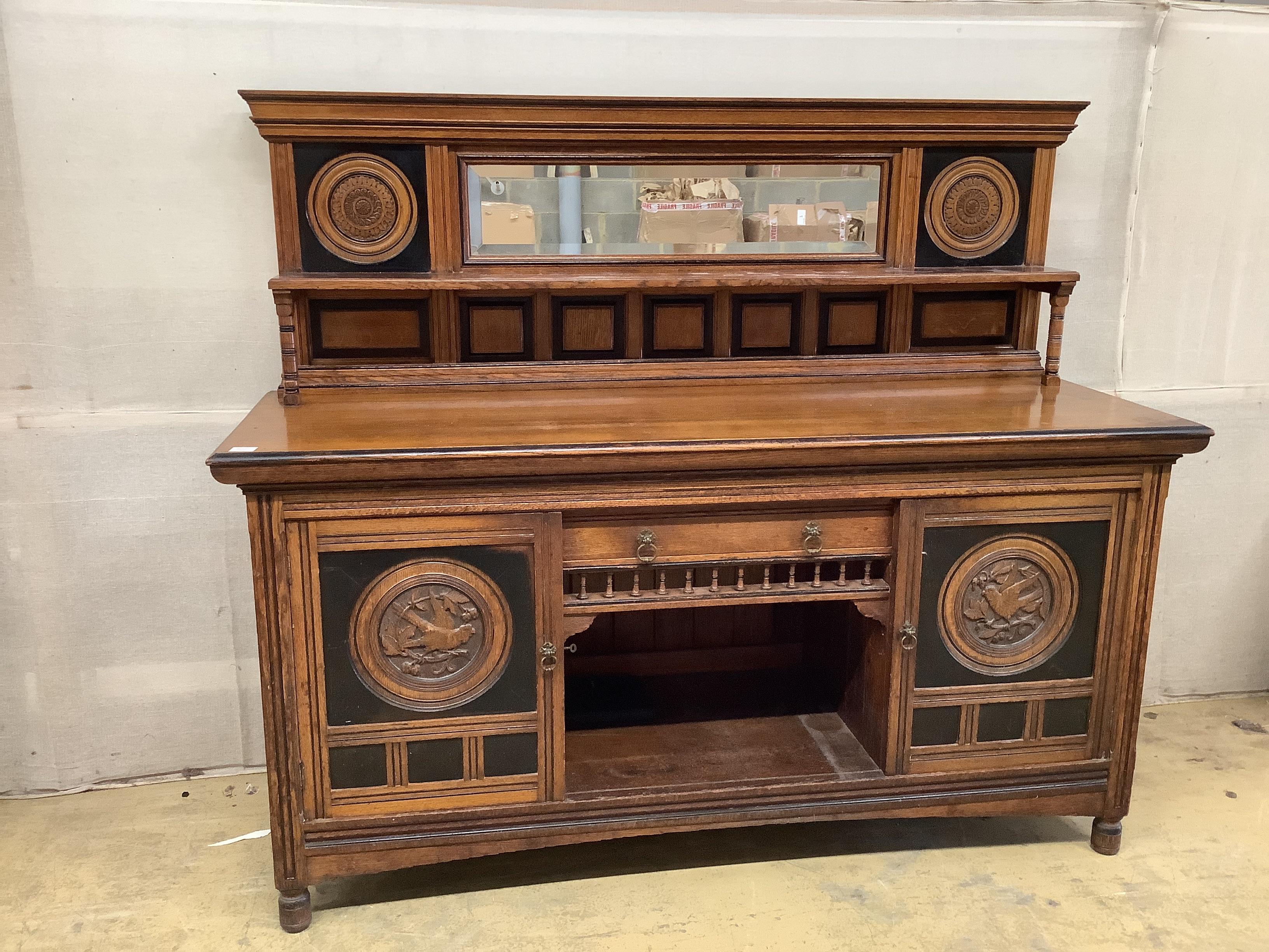 A late Victorian Aesthetic movement oak and parcel ebonised mirror back sideboard, width 183cm, depth 64cm, height 156cm